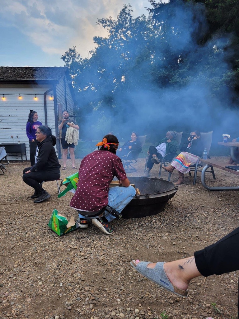Retreat participants gathered around an outdoor fire