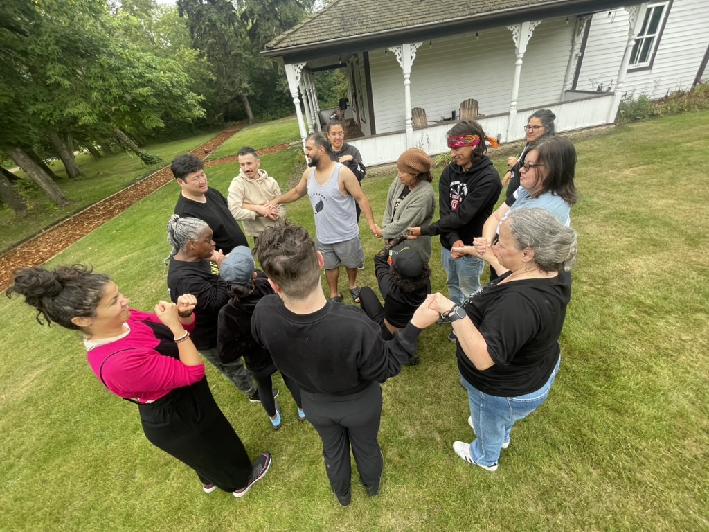 Artists sharing an outdoor group exercise at the previous retreat